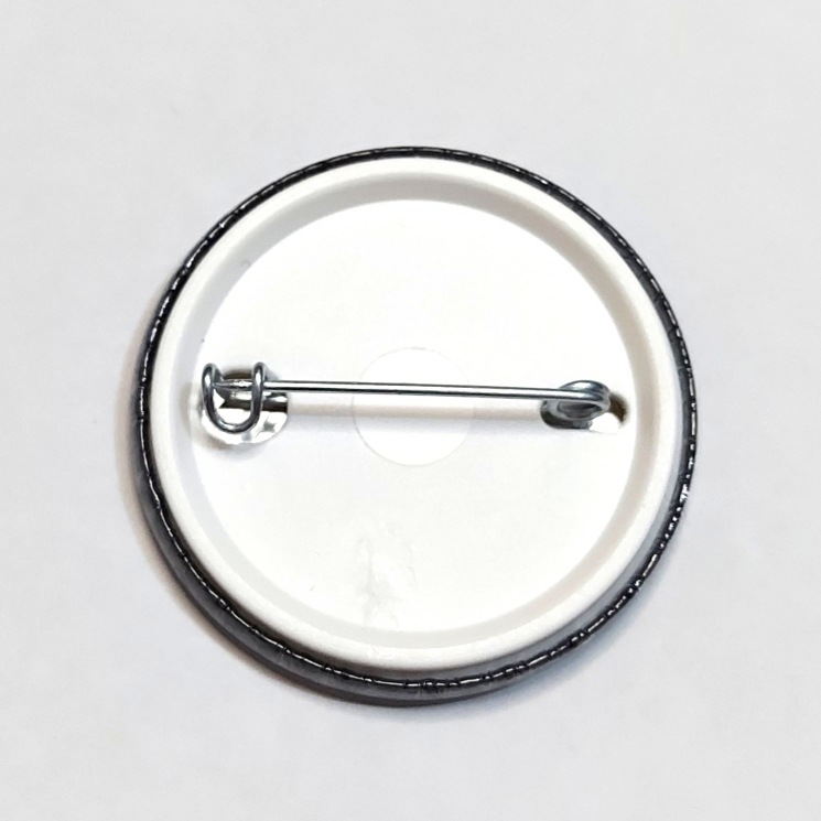 Back of a badge with a black border
