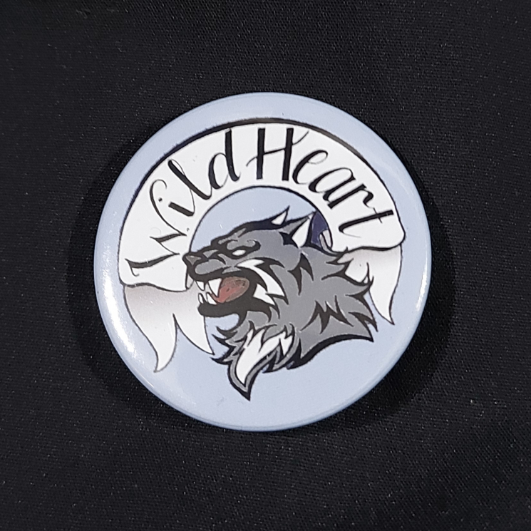 Pinback badge with banner reading "Wild Heart" and a snarling wolf
