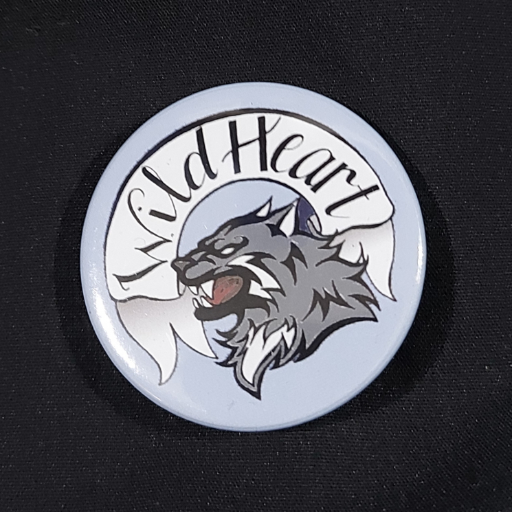 Pinback badge with banner reading "Wild Heart" and a snarling wolf