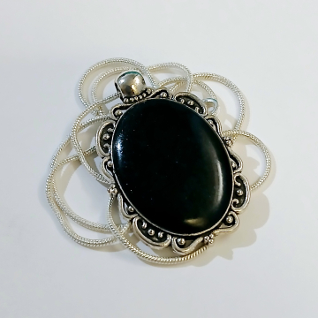 Silver oval pendant with black resin stone
