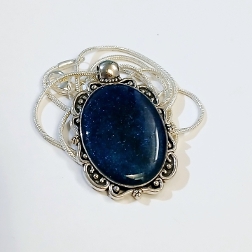 Silver oval pendant with deep blue resin stone